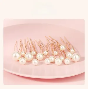 Detailed set of varied size pearls on rose gold hair pins for elegant bridal styling