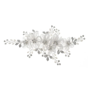 Detail of bridal hair comb with ivory fabric flowers, pearls, and crystal leaves