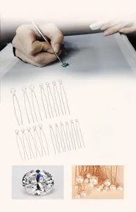 Detail of 10-piece gold U-shaped hair pins with white pearls and sparkling rhinestones