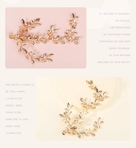 Close-up of golden floral leaf hair clip with white pearls and sparkling rhinestones