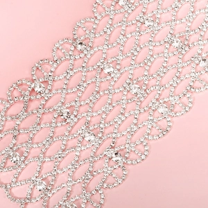 Macro detail of silver mesh face mask with sparkling rhinestones and grid texture