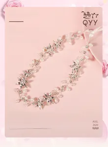 Close-up of handmade starfish bridal headband with rhinestones and white pearls