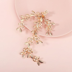 Elegant gold leaf and flower hair clip with sparkling rhinestones for bridal hairstyle