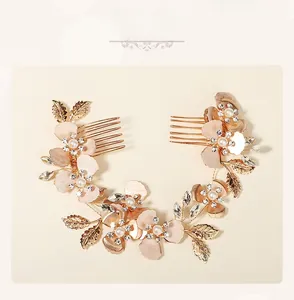 Detail of rose gold hair combs with shell petals, pearls, and crystals for bridal hair