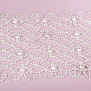 Macro detail of silver mesh rhinestone mask with intricate geometric lattice patterns