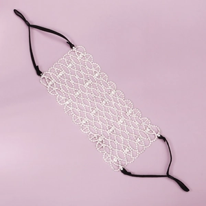 Close-up of sparkling silver rhinestone mesh mask with adjustable elastic black ear loops