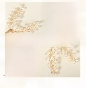 Detailed craftsmanship of handmade golden wire leaf hair clip with white teardrop pearls