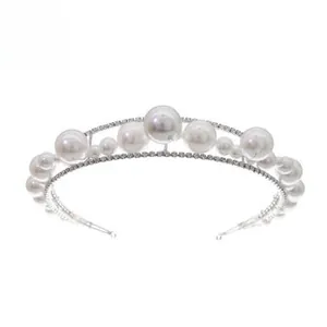 Detailed view of elegant bridal headband with white pearls and sparkling rhinestones