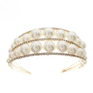 Detailed side view of a bridal hair hoop with large white pearls and sparkling rhinestones