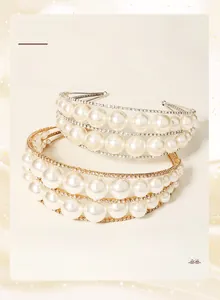 Detail of elegant pearl and rhinestone headbands in gold and silver finish