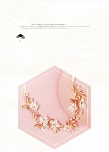 Detail of bridal headband with white flowers, pearls and golden leaves on pink background