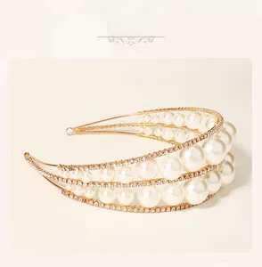 Detailed close-up of a multi-layer pearl headband with gold metal frame and sparkling rhinestones
