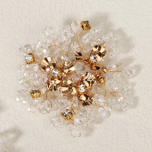 Detailed macro view of handmade gold floral shoe buckle with crystals and pearls