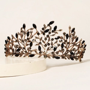 Detailed side view of Baroque bronze crown with black crystals and leaf-shaped rhinestones