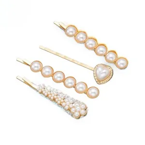 Lot de 4 barrettes dorées avec divers motifs en perles et détails en forme de cœur