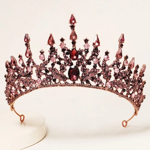 Macro shot of luxury baroque crown showing red crystal details and rose gold metal