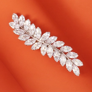 Macro shot of leaf-shaped silver hair clip with sparkling marquise-cut zircons
