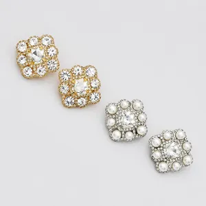 Close-up of square bridal ear cuffs with handmade pearls and sparkling rhinestones