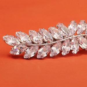 Macro view of marquise-cut cubic zirconia stones on an elegant leaf-shaped silver hair clip