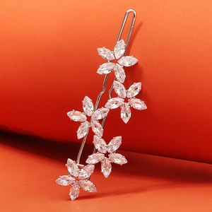 Gros plan détaillé d'une barrette argentée ornée de cinq fleurs en cristal de zircon