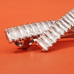 Macro detail of elegant hair clip featuring rectangular zircons on silver metal base