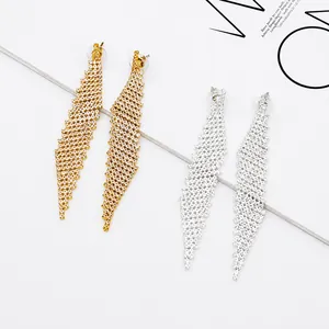 Detailed macro view of gold and silver crystal mesh bridal earrings with fringe tassels