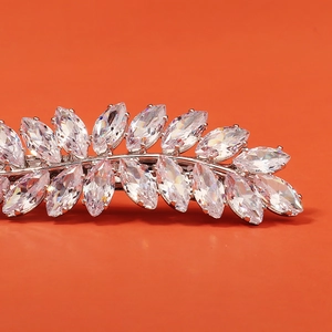 Macro shot of silver wheat leaf hair clip with marquise cut cubic zirconia stones