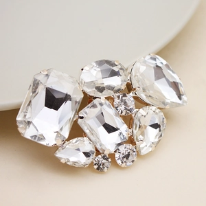 Macro detail of silver bridal shoe clip with sparkling rhinestone and crystal shapes