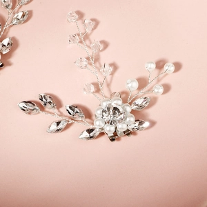 Macro shot of bridal shoe clip with luxury pearls and marquise cut crystal flowers