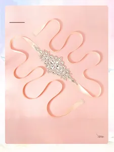 Detail of luxury bridal belt with marquise rhinestones on a pink satin ribbon sash