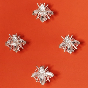 Lot de quatre pinces à cheveux abeilles argentées avec strass brillants sur orange