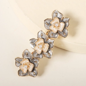 Barrette à fleurs vintage avec trois fleurs émaillées et accents de perles blanches