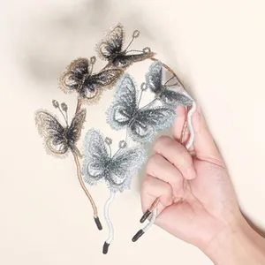 Detail of handmade embroidery butterfly headbands with pearls and wave metal frame