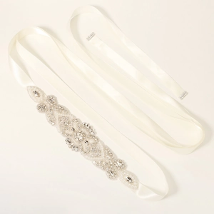 Detail of bridal sash featuring hand-sewn pearls and rhinestones on ivory satin ribbon