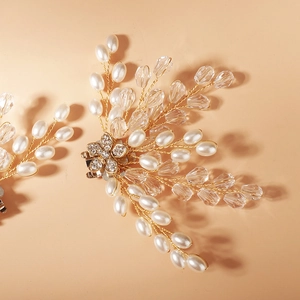 Close-up of luxury bridal hair clip with white pearls and crystal branch details