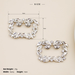 Detail view of silver rhinestone shoe clips measuring six centimeters by four centimeters