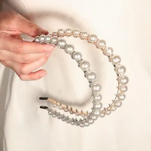 Detail view of handmade elegant pearl headbands with sparkling rhinestones and gold base