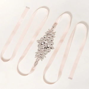 Detailed view of luxury rhinestone belt with elegant champagne pink satin ribbon