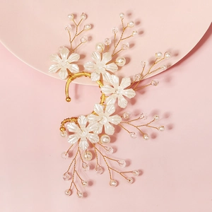 Detailed close-up of handmade bridal ear cuff with pearls and floral crystal design