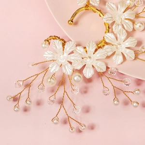 Detail of bridal ear cuff with resin flowers, pearls and crystals on gold wire