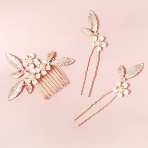 Macro detail of handmade pearl flower hair comb and U-shaped pins for wedding hairstyles