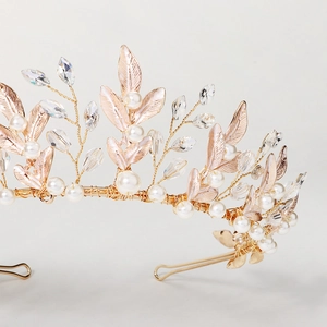 Detail of handmade gold leaf crown with white pearls and crystals on a slim headband
