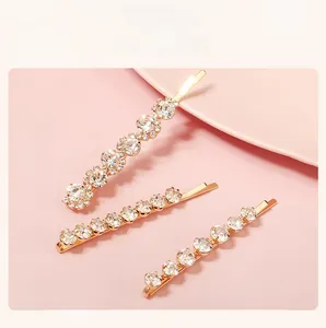 Three-piece set of golden hair clips with sparkling rhinestones in various sizes and patterns