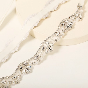 Elegant bridal wedding belt featuring sparkling rhinestones and white pearls on sheer mesh