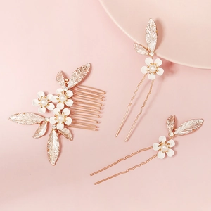 Three-piece bridal hair set with gold floral combs and pearl U-shaped pins on pink background