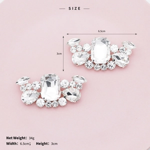 Detail view of sparkling crystal shoe clips with large rectangular rhinestone and silver base