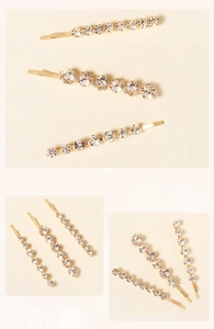 Close-up of gold-plated hair clips set with sparkling rhinestones in a macro view