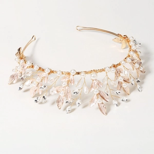 Detail of bridal headband with white pearls, rose gold leaves and crystals