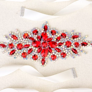 Macro shot of luxury red crystal bridal belt with silver AB rhinestones and white satin