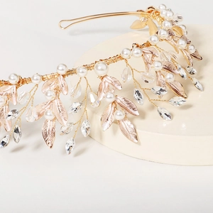 Elegant gold bridal crown with delicate metal leaves, white pearls and sparkling crystals